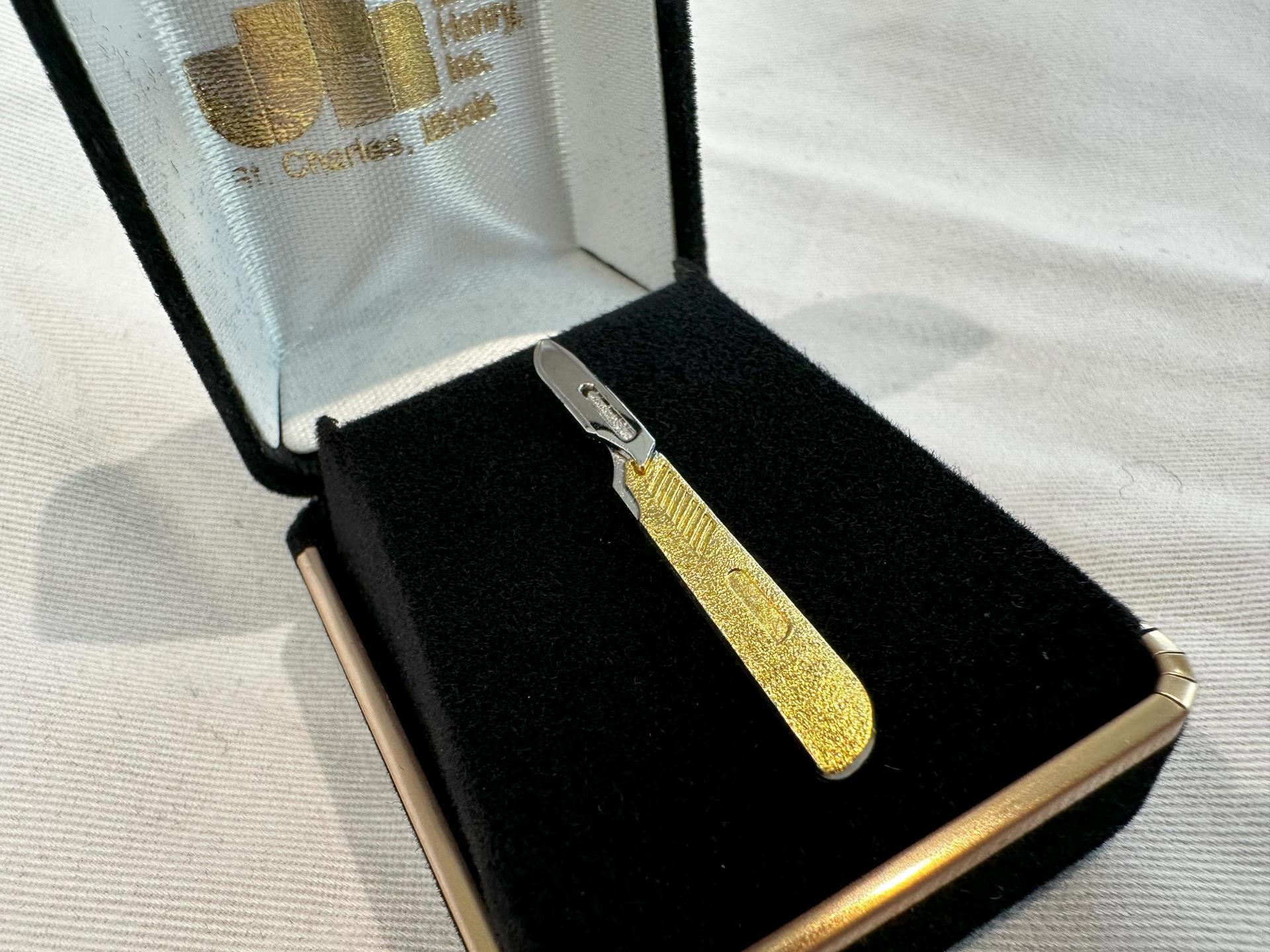 Receive a Scalpel Pin with a Donation to the ACS Foundation